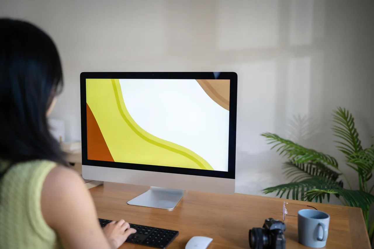 A designer working at an iMac in a home studio