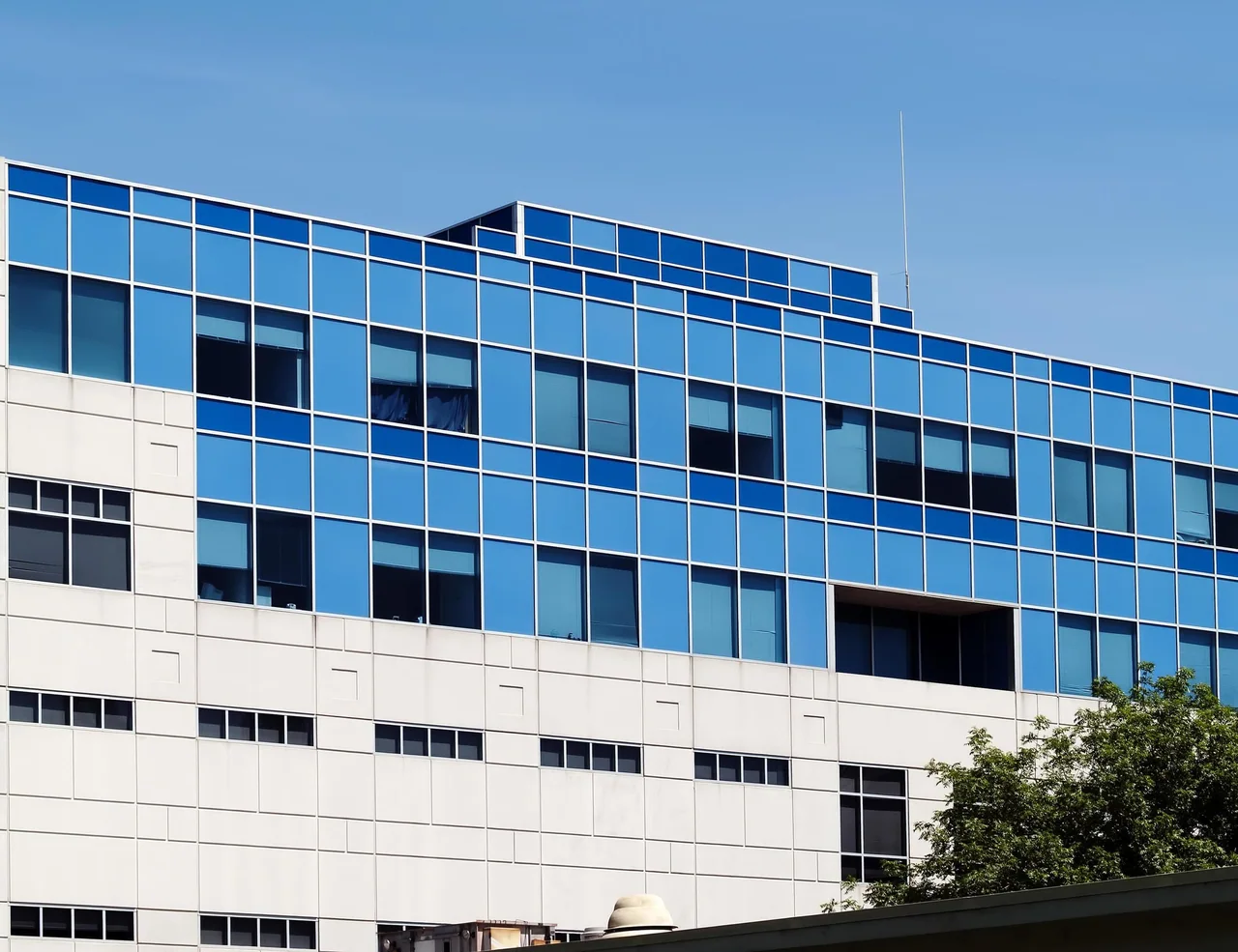 A modern medical building with blue glass windows
