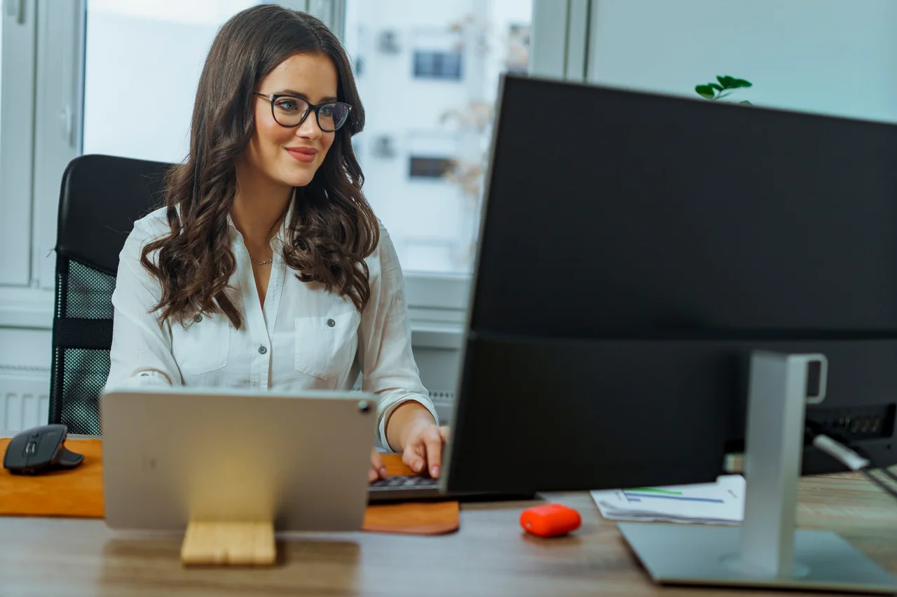 A lawyer working at her computer in a bright office