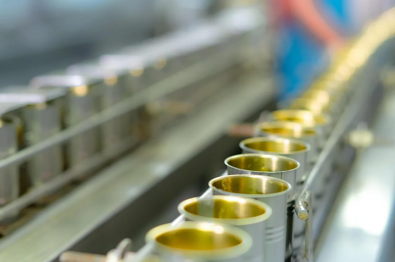 Cans moving along a production line in a factory